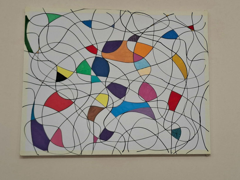 The community collective neuro canvas at Smyrna, featuring tangled black lines and vibrantly coloured shapes, including red, blue, and yellow, creating a dynamic, chaotic feel. Chaotic until complete!