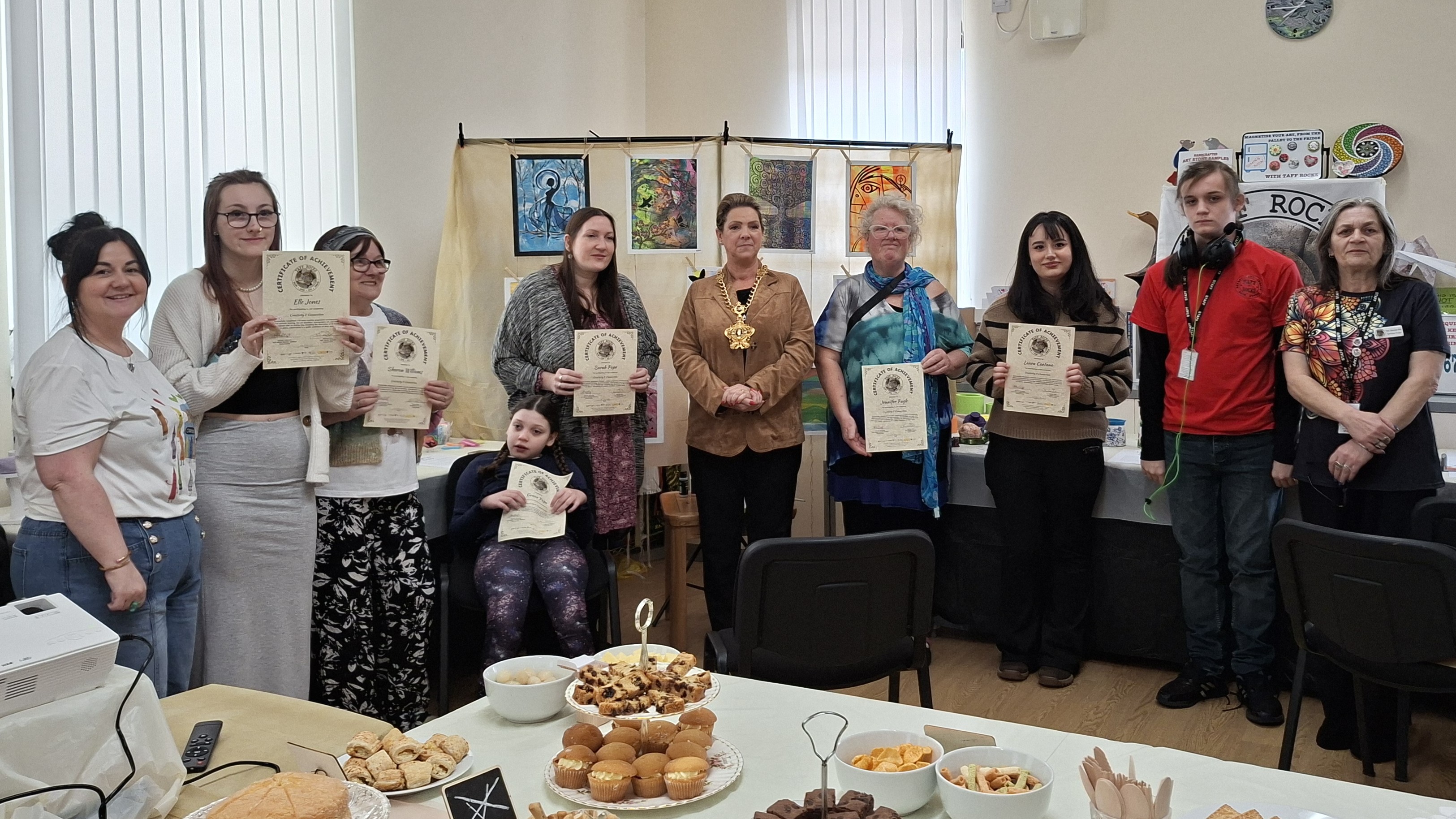 image of artists at exhibition receiving their certificates from the Mayor of Merthyr Tydfil