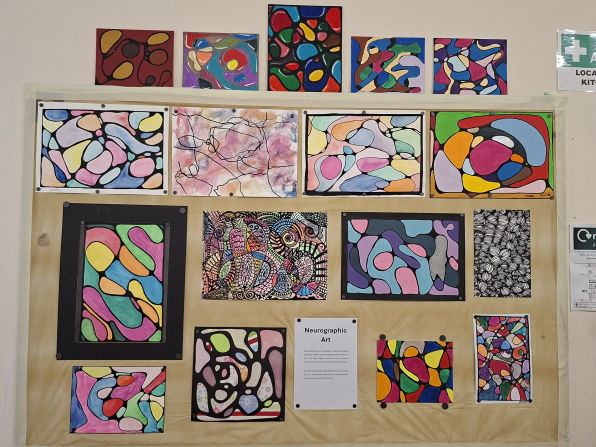 Exhibition board displaying vibrant neurographic artworks. Each piece features colourful, abstract designs with fluid shapes and lines, creating a dynamic, expressive atmosphere.