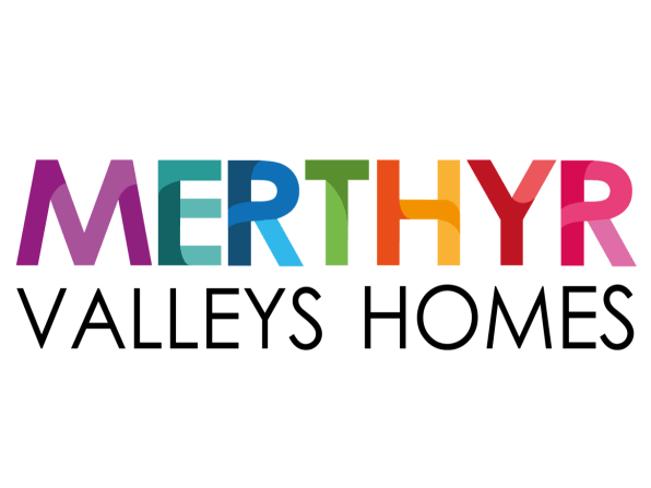 Logo of "Merthyr Valleys Homes" with "MERTHYR" in bold, colorful letters and "VALLEYS HOMES" in black, conveying diversity and vibrancy.